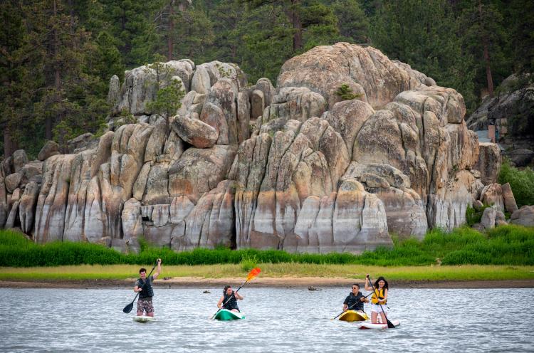 Family of four kayaking in Boulder Bay, on Big Bear Lake