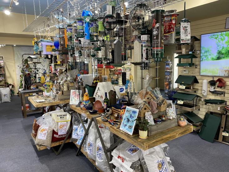 A collection of bird feeders and bird houses hang from the ceiling at Chirp Nature Center in Big Bear Lake.