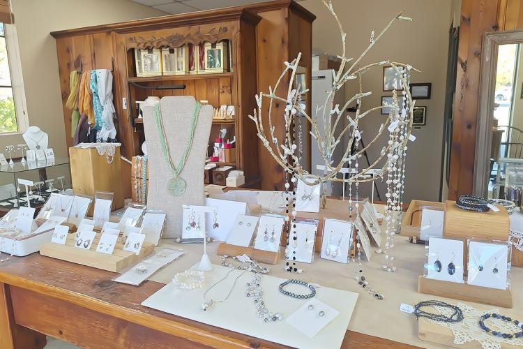 Un gran expositor de mesa en el que se muestran las joyas de Silver Fawn: hay pulseras, pendientes y collares.