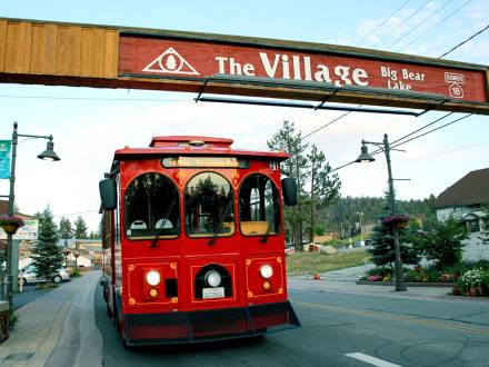 El Mountain Trolley pasando por debajo de "The Village Sign" de Big Bear