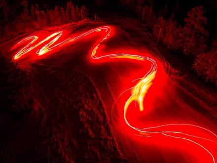 Un chorro de antorchas encendidas ilumina una pista de esquí durante un desfile de Año Nuevo en Big Bear, California. Toma de larga exposición.