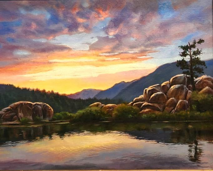 Ganadora del primer premio del concurso de arte Plein Air 2024, su obra muestra la puesta de sol reflejándose suavemente en el lago.