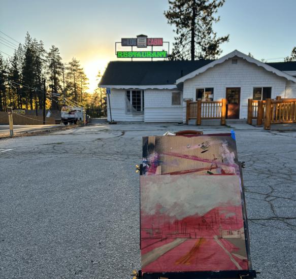 Su cuadro, que se presentó al concurso Plein Air, representa la Log Cabin del Boulevard durante una puesta de sol.