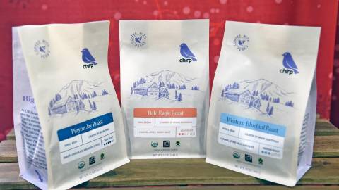 A photo of three types of coffees from Big Bear Chirp, featuring flavors like chocolate, molasses, apple, and caramel.