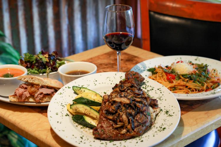 A photo of Sweet Basil Bistro's fine dining options, the dishes shown are steak, pasta, and a sandwich with tomato soup