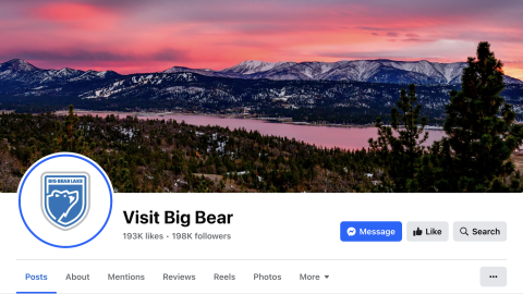 The Visit Big Bear Facebook page, the page's banner depicts the snow topped mountains during a pink-ish orange colored sunset